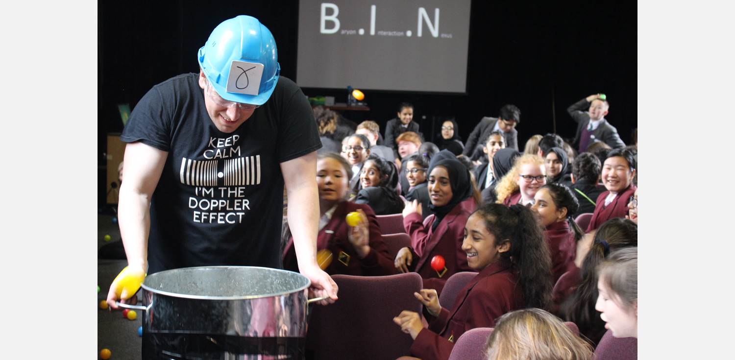 A physics demonstration in front of an audience of school children